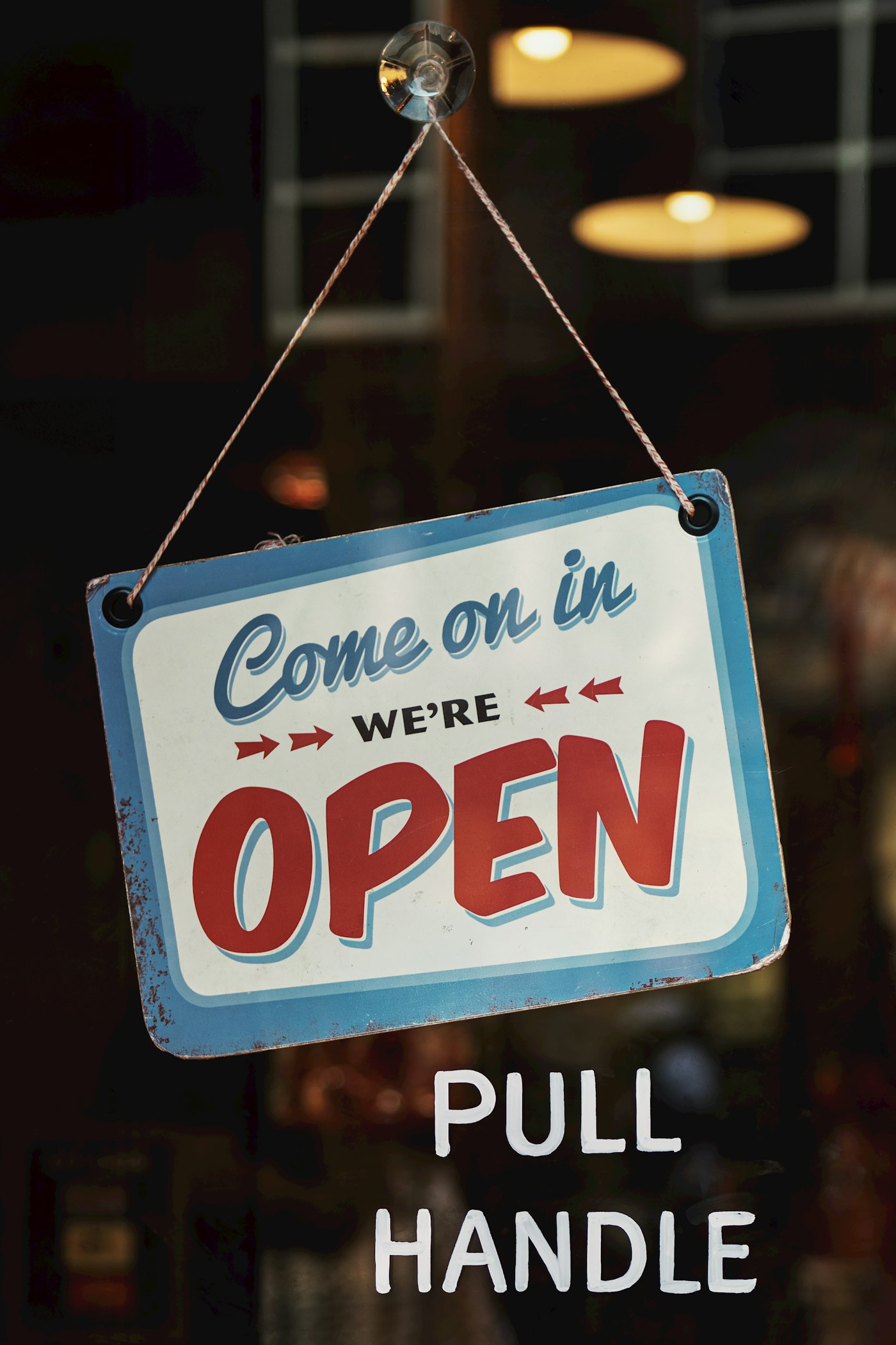 Local shop entrance with an "open" sign in the window
