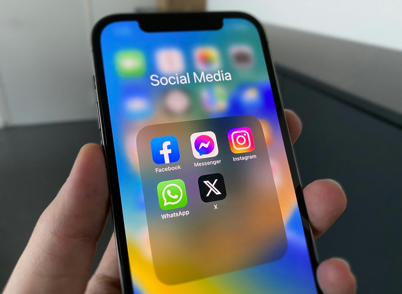 Hand holding a phone showing a social media feed