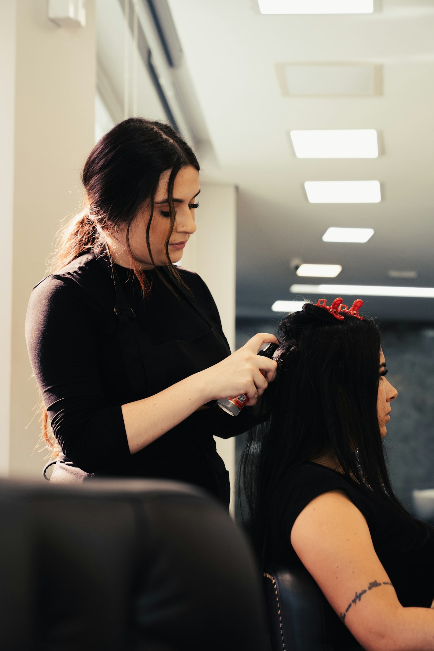 Hair stylist working with a client in a salon